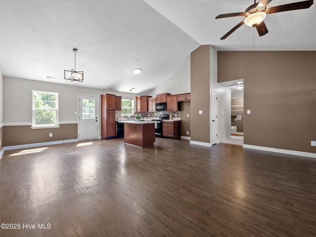 212 Peaceful Ln, Hubert, NC 28539 - unfurnished living room featuring vaulted ceiling, baseboards, a ceiling fan, and dark wood-style flooring