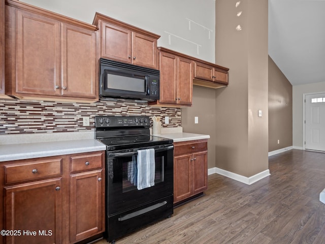 212 Peaceful Ln, Hubert, NC 28539 - kitchen with brown cabinets, black appliances, and dark wood-type flooring