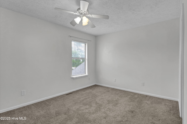 10165 Creekside Dr SE Apt 1, Leland, NC 28451 - carpeted spare room featuring a textured ceiling, baseboards, and ceiling fan