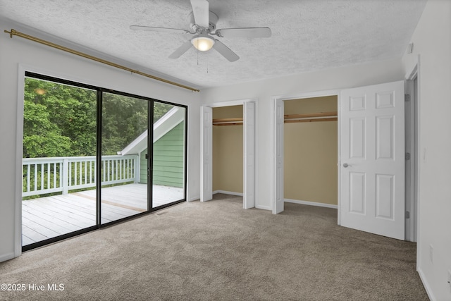 10165 Creekside Dr SE Apt 1, Leland, NC 28451 - unfurnished bedroom with two closets, access to outside, carpet, a textured ceiling, and ceiling fan
