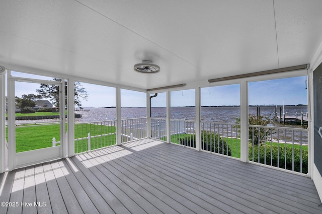 unfurnished sunroom featuring a water view