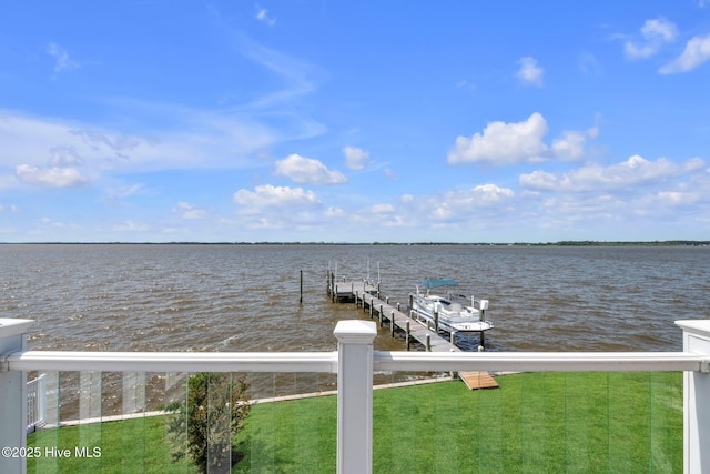 dock area with a lawn and a water view