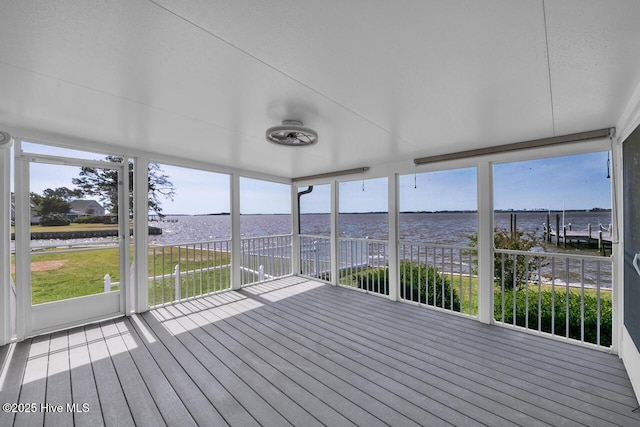 unfurnished sunroom featuring plenty of natural light and a water view