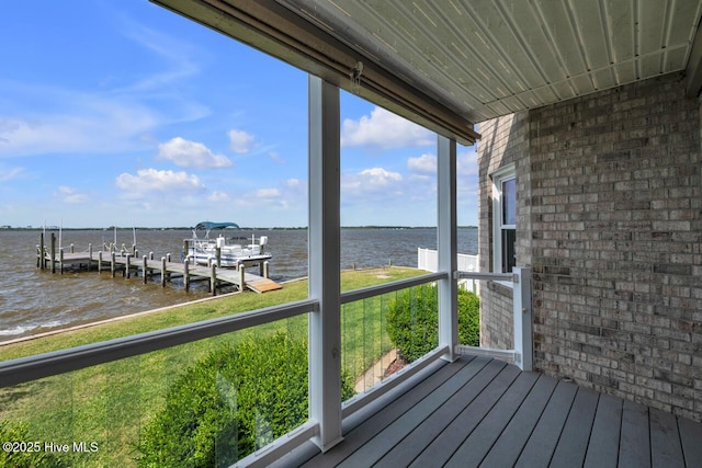 wooden terrace with a water view and a dock