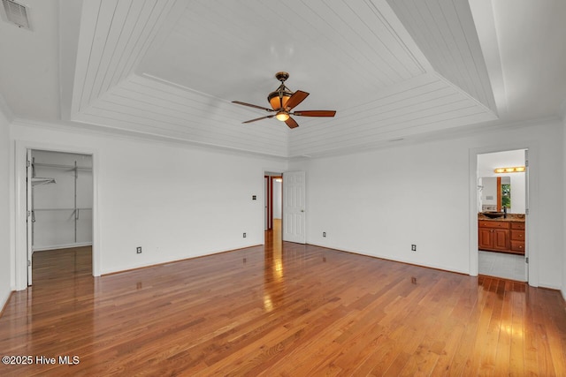 interior space featuring visible vents, wooden ceiling, light wood finished floors, and a raised ceiling