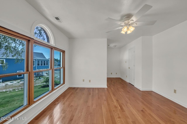 unfurnished room featuring baseboards, ceiling fan, light wood-style flooring, and visible vents