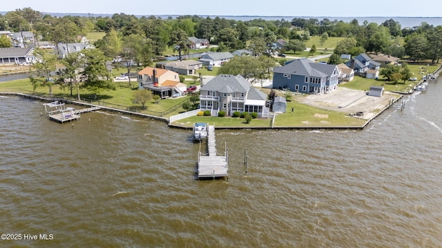 drone / aerial view featuring a water view and a residential view