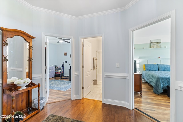 corridor featuring wood finished floors and ornamental molding