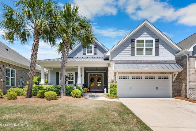 2465 Meridian Rd NE, Leland, NC 28451 - craftsman-style house featuring a front lawn, french doors, a garage, concrete driveway, and a standing seam roof
