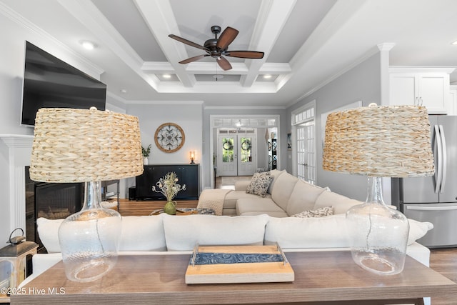 2465 Meridian Rd NE, Leland, NC 28451 - living area with crown molding, beam ceiling, a fireplace, a ceiling fan, and wood finished floors