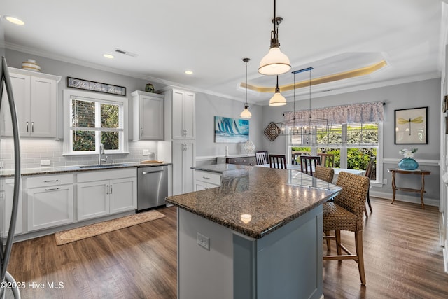 2465 Meridian Rd NE, Leland, NC 28451 - kitchen with a kitchen island, a kitchen bar, visible vents, appliances with stainless steel finishes, and a sink