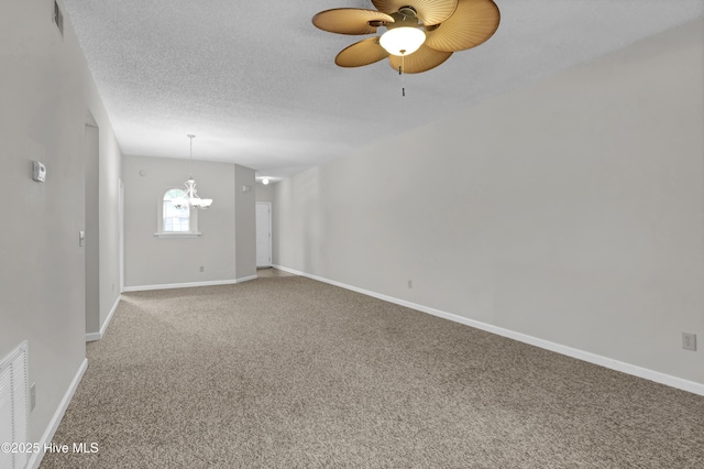 spare room featuring ceiling fan, carpet floors, baseboards, and a textured ceiling