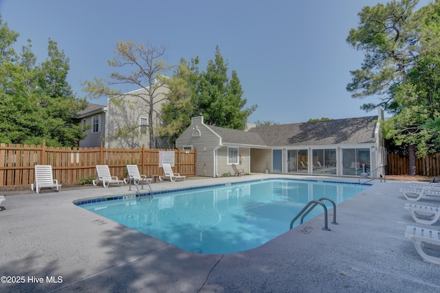 community pool featuring a patio area and fence