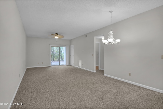spare room featuring carpet flooring, a textured ceiling, a chandelier, a ceiling fan, and baseboards
