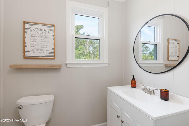 bathroom featuring plenty of natural light, toilet, and vanity