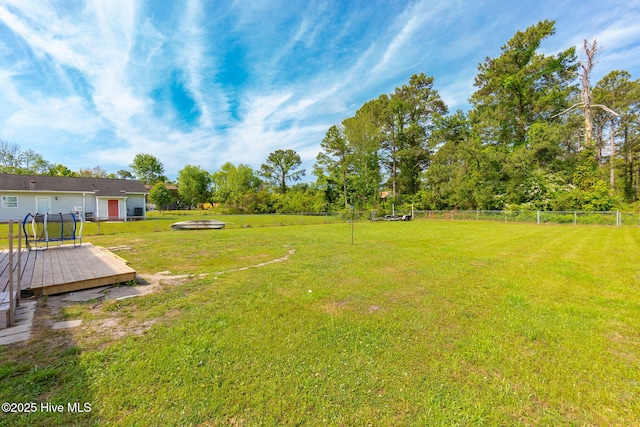 view of yard featuring a deck and fence