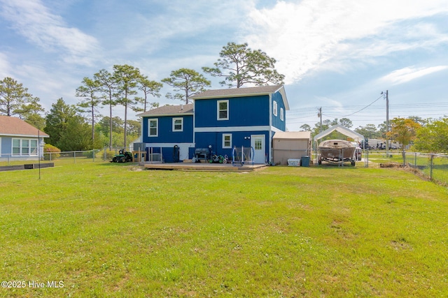 back of property featuring a yard, a wooden deck, a fenced backyard, and a carport