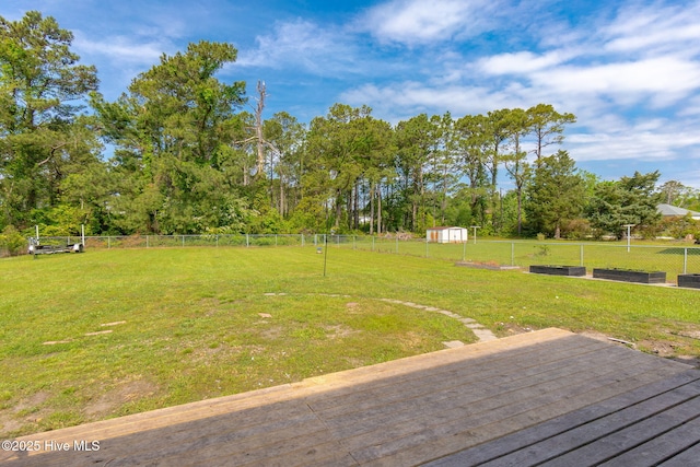 view of yard with fence and a vegetable garden