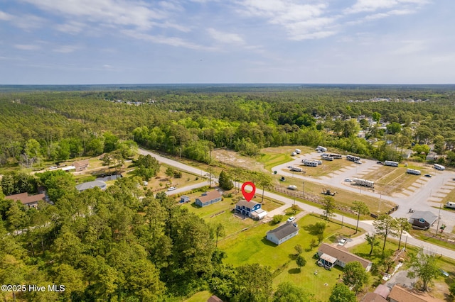 drone / aerial view featuring a view of trees