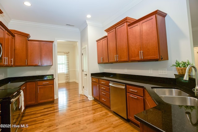 4 Cordelia Way, Vass, NC 28394 - kitchen featuring dark stone counters, appliances with stainless steel finishes, a sink, and light wood-type flooring