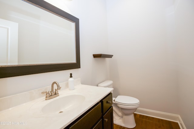 4 Cordelia Way, Vass, NC 28394 - bathroom featuring vanity, baseboards, toilet, and wood finished floors