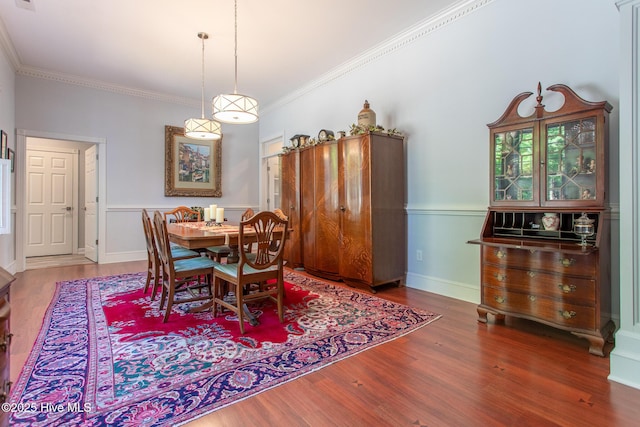 dining room featuring ornamental molding and wood finished floors