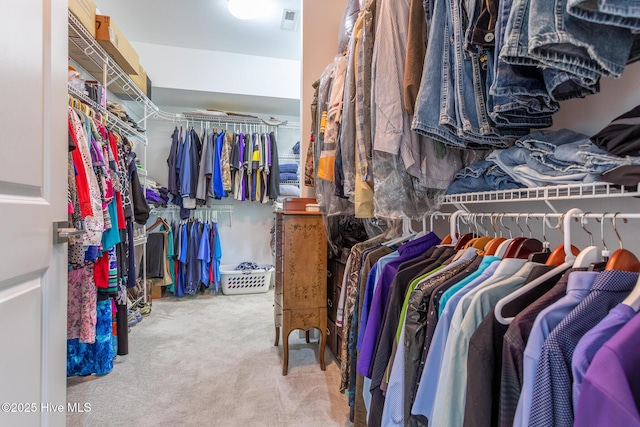 walk in closet featuring carpet flooring and visible vents