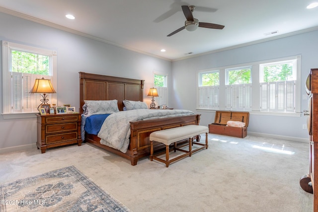bedroom featuring crown molding, baseboards, and light colored carpet