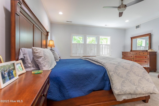 carpeted bedroom featuring visible vents, ornamental molding, and ceiling fan