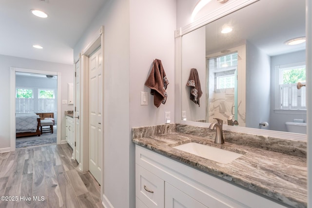 full bathroom featuring wood finished floors, vanity, toilet, ensuite bathroom, and recessed lighting