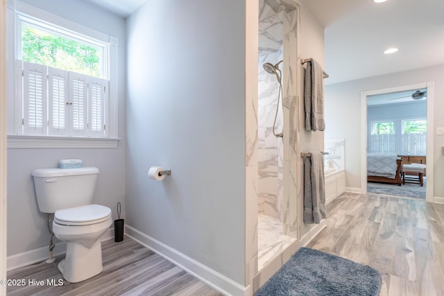 ensuite bathroom with connected bathroom, toilet, a marble finish shower, baseboards, and wood finished floors