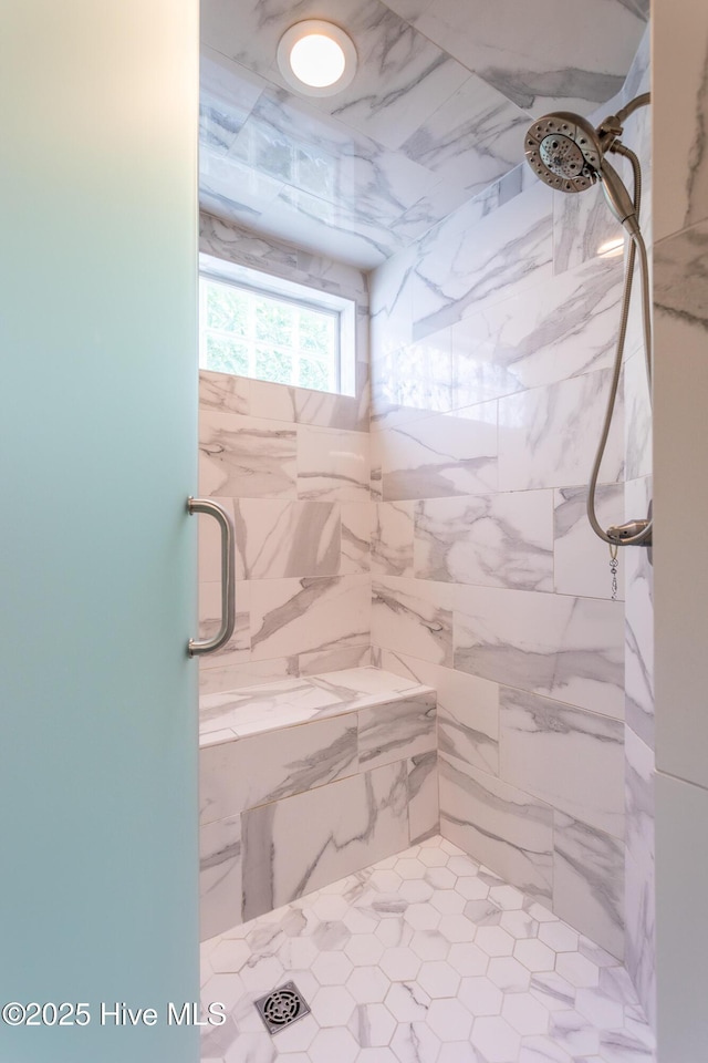 full bathroom with a marble finish shower