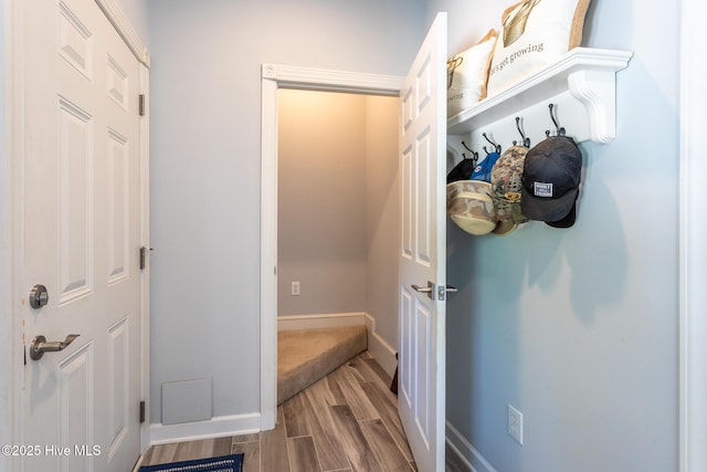 mudroom with baseboards and wood finish floors