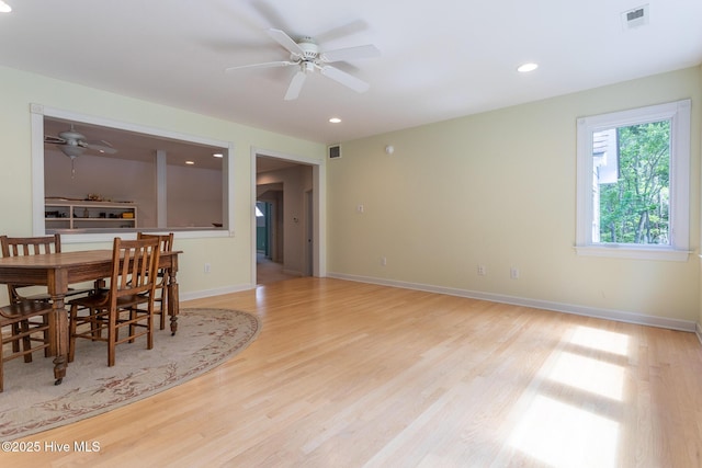 dining area featuring visible vents, light wood-style flooring, and ceiling fan