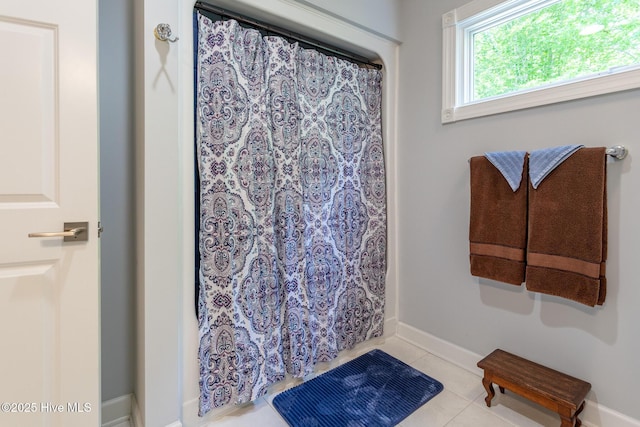 full bath with tile patterned floors, baseboards, and a shower with curtain