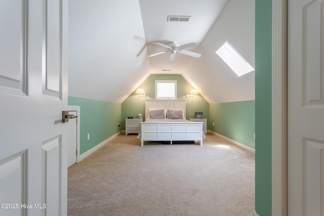 bedroom with visible vents, baseboards, lofted ceiling with skylight, and light carpet