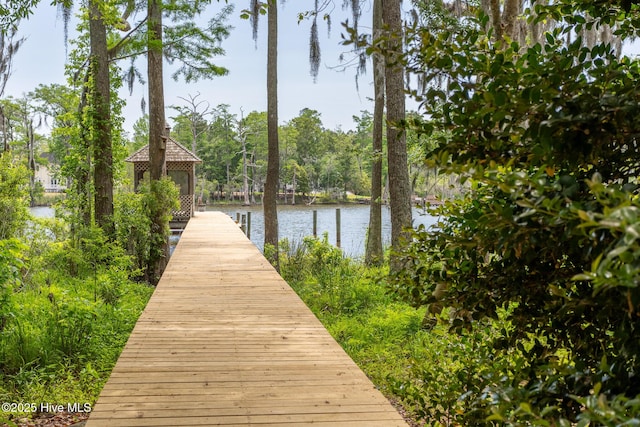 view of dock with a gazebo and a water view