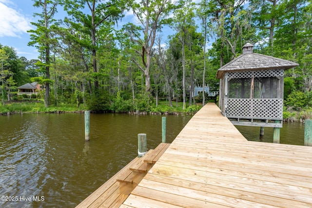 view of dock with a gazebo and a water view