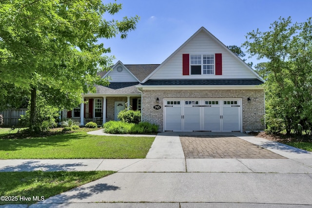 745 Royal Bonnet Dr, Wilmington, NC 28405 - craftsman-style home featuring brick siding, driveway, a shingled roof, and a front yard