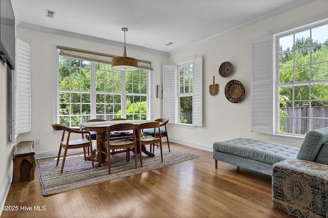 745 Royal Bonnet Dr, Wilmington, NC 28405 - dining space with crown molding, baseboards, visible vents, and wood finished floors