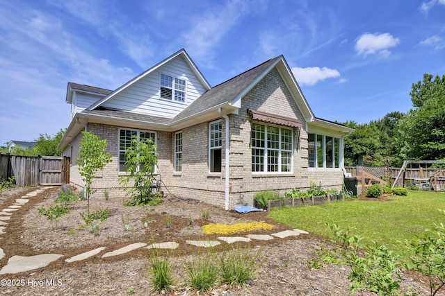 745 Royal Bonnet Dr, Wilmington, NC 28405 - view of side of home featuring a lawn, brick siding, fence, and a gate
