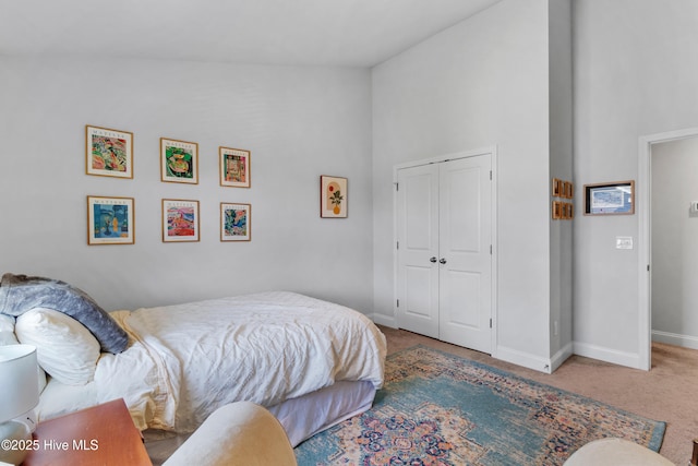 4739 Oyster Reef, Wilmington, NC 28405 - bedroom with carpet flooring, baseboards, high vaulted ceiling, and a closet