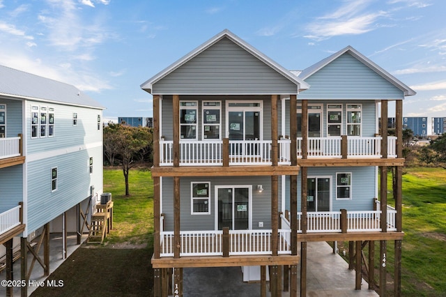 146 Sea Gull Ln, North Topsail Beach, NC 28460 - view of front of home with a carport, a front lawn, and a balcony