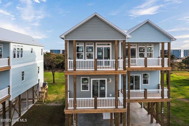 146 Sea Gull Ln, North Topsail Beach, NC 28460 - view of front of home with a carport, a front lawn, and a balcony
