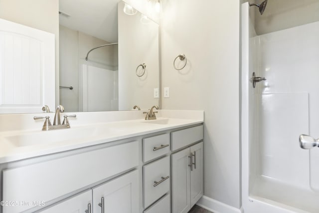 146 Sea Gull Ln, North Topsail Beach, NC 28460 - bathroom featuring a sink, double vanity, a shower, and visible vents