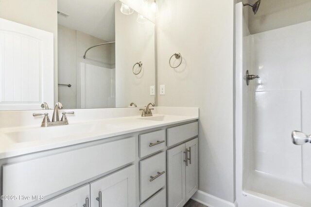 146 Sea Gull Ln, North Topsail Beach, NC 28460 - bathroom featuring a sink, double vanity, a shower, and visible vents