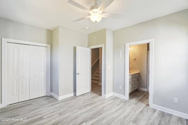 146 Sea Gull Ln, North Topsail Beach, NC 28460 - unfurnished bedroom featuring ceiling fan, baseboards, a closet, light wood-style floors, and ensuite bath