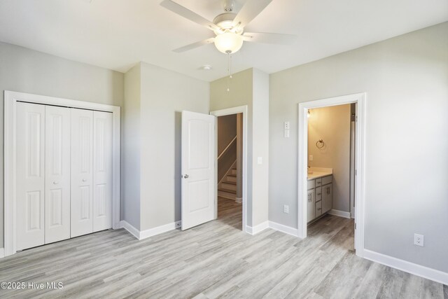 146 Sea Gull Ln, North Topsail Beach, NC 28460 - unfurnished bedroom featuring ceiling fan, baseboards, a closet, light wood-style floors, and ensuite bath