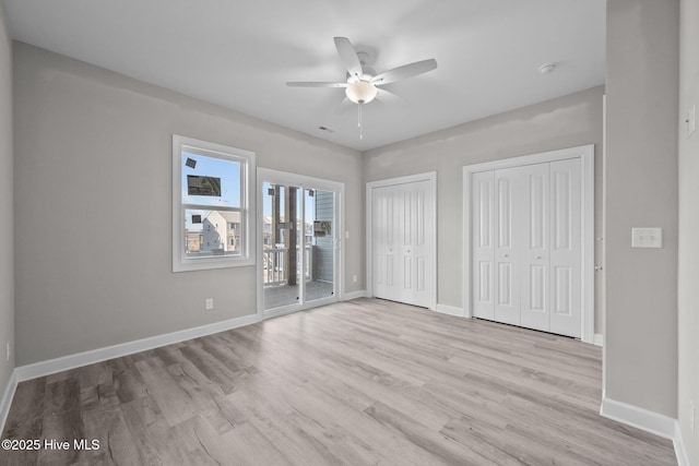 146 Sea Gull Ln, North Topsail Beach, NC 28460 - unfurnished bedroom with two closets, access to exterior, baseboards, light wood-type flooring, and a ceiling fan