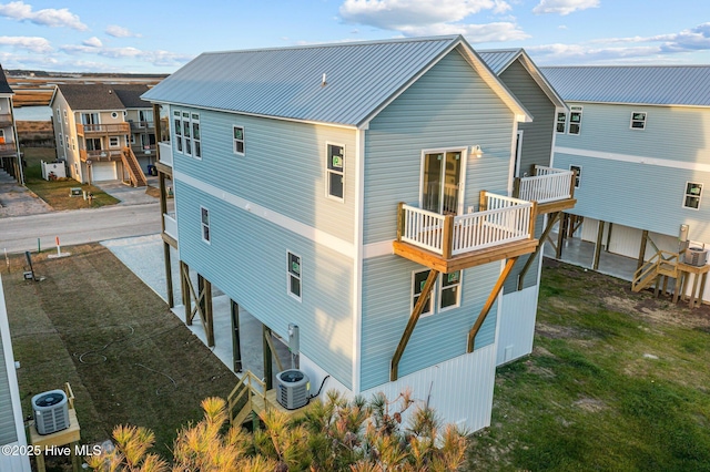 146 Sea Gull Ln, North Topsail Beach, NC 28460 - back of property featuring metal roof, central AC unit, and a balcony